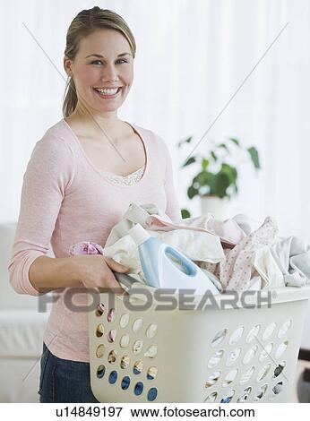 Stock Photo - Woman holding laundry basket. Fotosearch