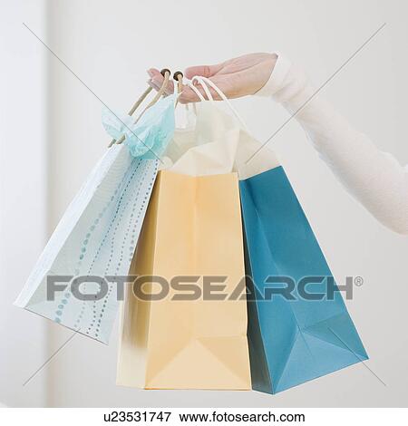 Woman holding shopping bags View Large Photo Image Stock Photo - Woman holding shopping bags. Fotosearch