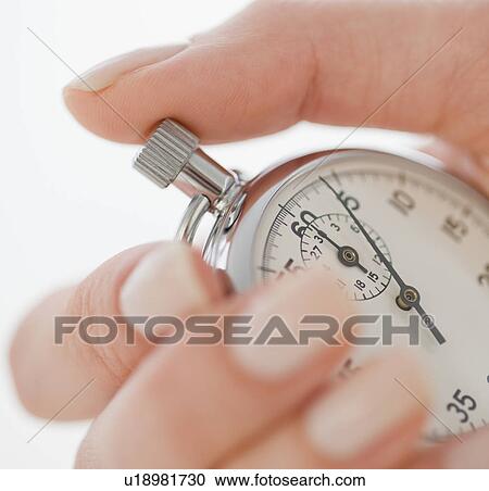 Woman holding stopwatch View Large Photo Image Stock Image - Woman holding stopwatch. Fotosearch