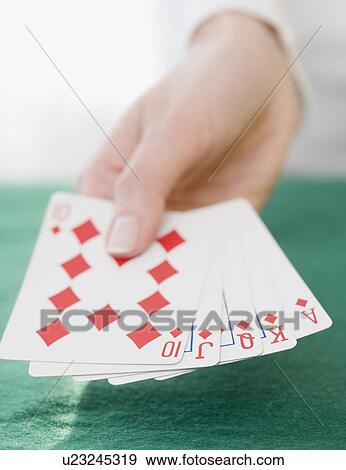 Stock Photo - Woman holding straight flush playing cards. Fotosearch