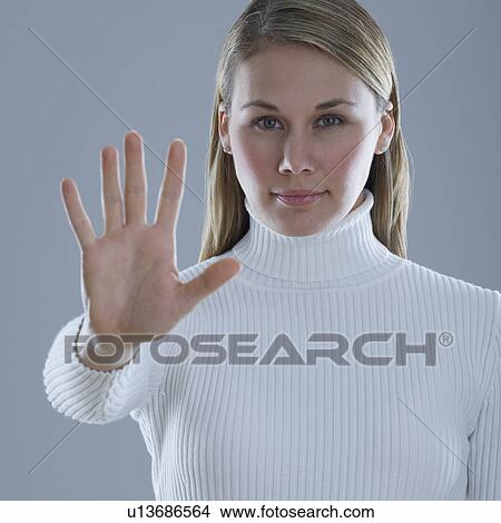 Picture - Woman holding up hand with palm out. Fotosearch