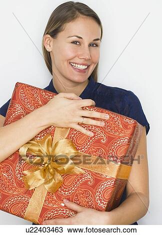 Woman hugging gift View Large Photo Image Stock Image - Woman hugging gift. Fotosearch