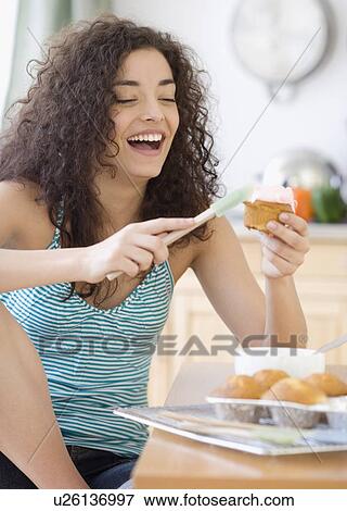 Woman icing cupcakes View Large Photo Image Stock Photo - Woman icing cupcakes. Fotosearch