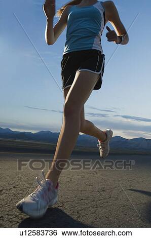 Woman in athletic gear running View Large Photo Image Stock Photograph - Woman in athletic gear running. Fotosearch