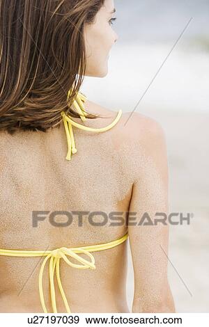Stock Photo - Woman in bikini with sand on back. Fotosearch