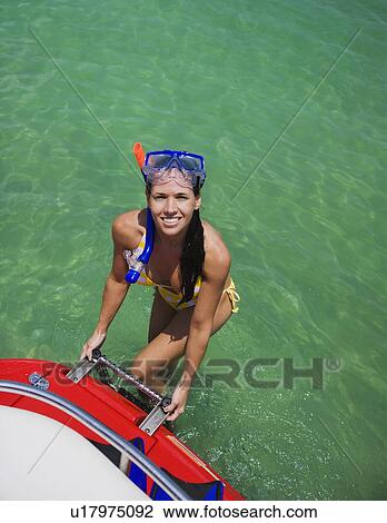 Woman in snorkeling gear climbing off boat, Florida, United States View Large Photo Image Stock Image - Woman in snorkeling gear climbing off boat, Florida, United States. Fotosearch