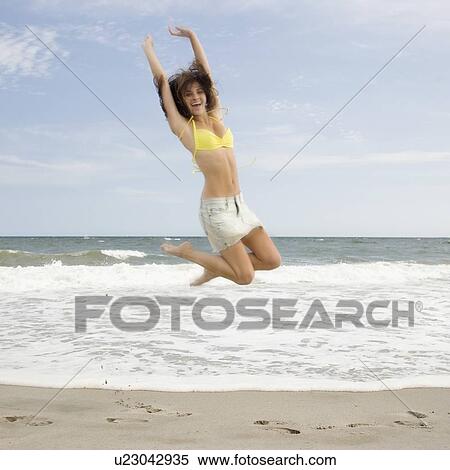 Woman jumping at beach View Large Photo Image Stock Photography - Woman jumping at beach. Fotosearch