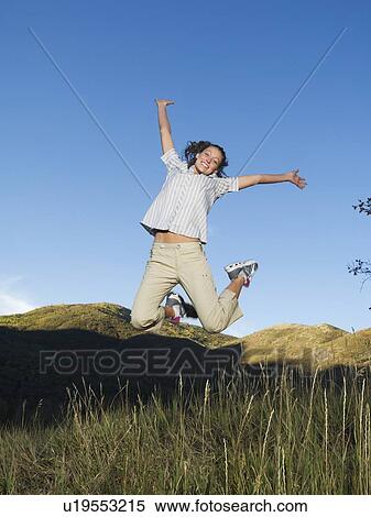 Woman jumping in field, Utah, United States View Large Photo Image Stock Photography - Woman jumping in field, Utah, United States. Fotosearch