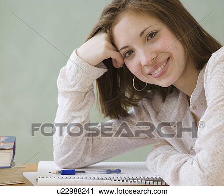 Stock Image - Woman leaning on notebook. Fotosearch