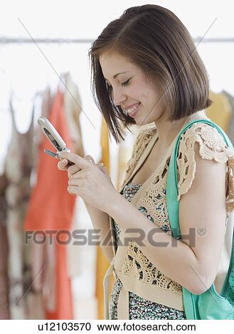 Woman looking at cell phone View Large Photo Image Stock Image - Woman looking at cell phone. Fotosearch