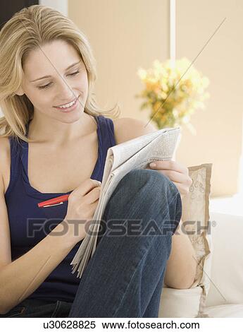 Woman looking at newspaper View Large Photo Image Stock Photography - Woman looking at newspaper . Fotosearch