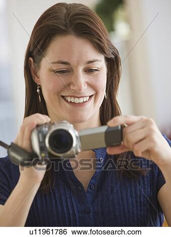 Stock Photograph - Woman looking at video camera. Fotosearch
