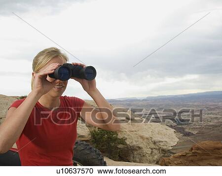 Woman looking through binoculars View Large Photo Image Stock Image - Woman looking through binoculars. Fotosearch
