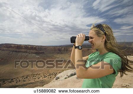Woman looking through binoculars View Large Photo Image Stock Image - Woman looking through binoculars. Fotosearch