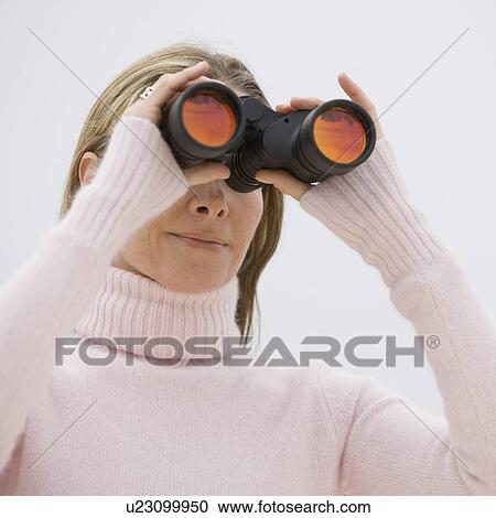 Stock Image - Woman looking through binoculars. Fotosearch