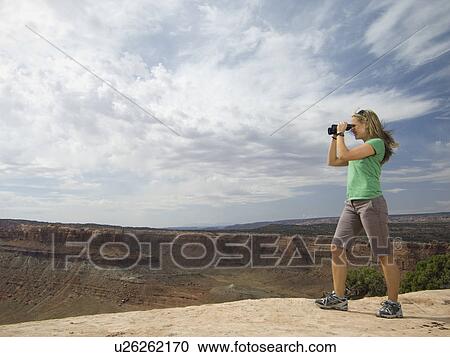 Woman looking through binoculars View Large Photo Image Stock Image - Woman looking through binoculars. Fotosearch