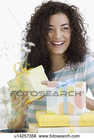 Woman opening gifts View Large Photo Image Stock Photo - Woman opening gifts. Fotosearch