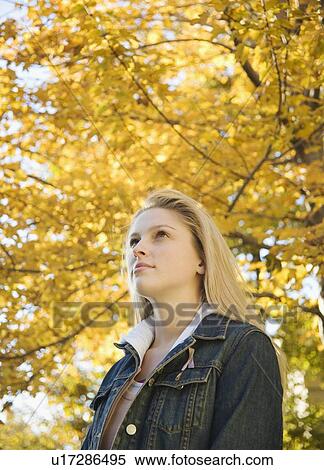 Stock Photography - Woman outdoors on a fall day. Fotosearch