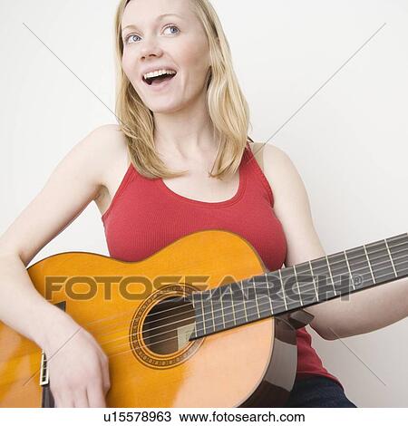 Woman paying acoustic guitar View Large Photo Image Stock Image - Woman paying acoustic guitar. Fotosearch