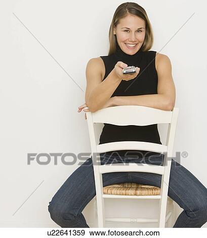 Woman pointing remote control View Large Photo Image Stock Photo - Woman pointing remote control. Fotosearch