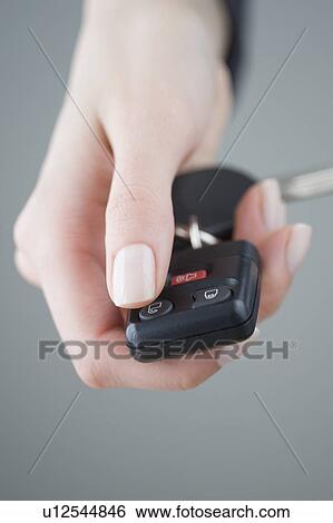 Woman pressing unlock button on keychain View Large Photo Image Stock Photograph - Woman pressing unlock button on keychain. Fotosearch
