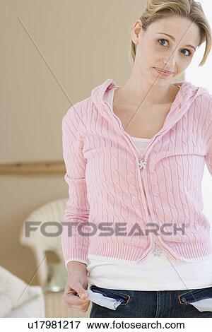 Woman pulling out pockets of jeans View Large Photo Image Stock Photo - Woman pulling out pockets of jeans. Fotosearch