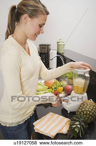Woman pushing button on blender View Large Photo Image Stock Photo - Woman pushing button on blender. Fotosearch