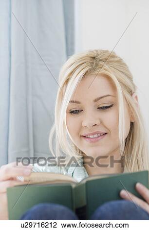 Stock Image - Woman reading book. Fotosearch