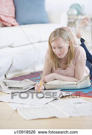 Woman reading newspaper classifieds View Large Photo Image Stock Photograph - Woman reading newspaper classifieds. Fotosearch