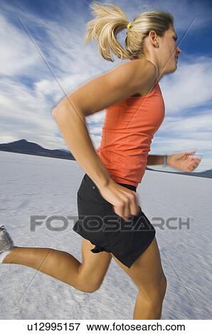 Woman running on salt flats, Utah, United States View Large Photo Image Stock Photo - Woman running on salt flats, Utah, United States. Fotosearch