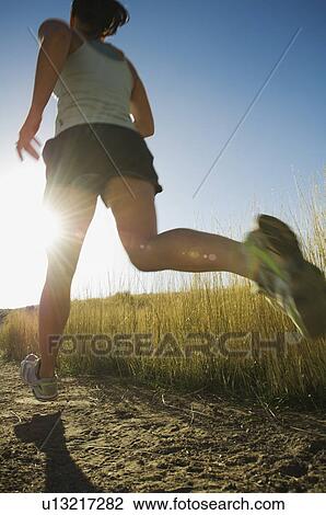 Woman running on trail, Salt Flats, Utah, United States View Large Photo Image Stock Image - Woman running on trail, Salt Flats, Utah, United States. Fotosearch
