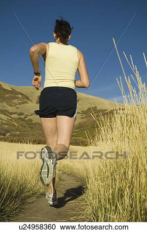 Woman running on trail, Utah, United States View Large Photo Image Stock Image - Woman running on trail, Utah, United States. Fotosearch