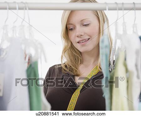 Woman shopping for clothing View Large Photo Image Stock Image - Woman shopping for clothing. Fotosearch