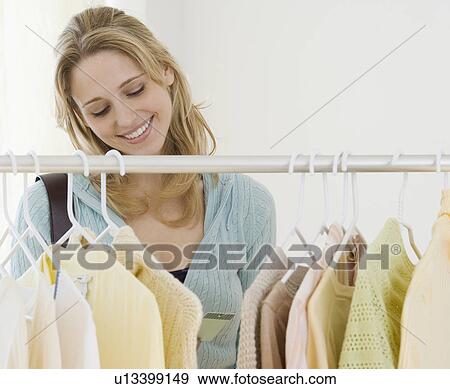 Stock Photo - Woman shopping for clothing. Fotosearch
