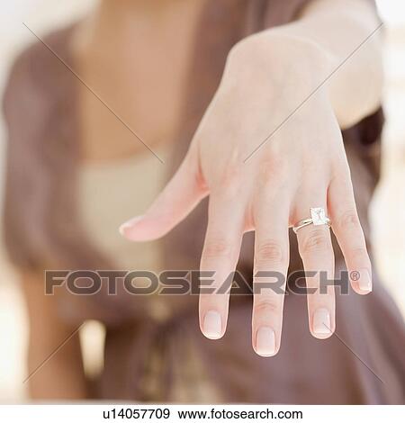 Stock Photo - Woman showing off engagement ring. Fotosearch