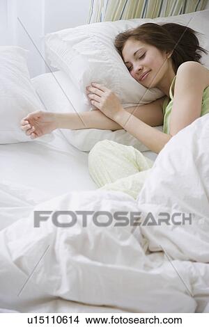 Woman sleeping in bed View Large Photo Image Picture - Woman sleeping in bed. Fotosearch