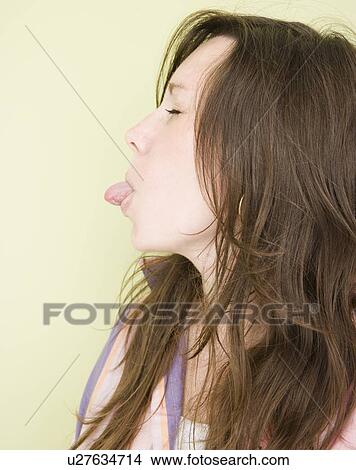 Woman sticking tongue out View Large Photo Image Picture - Woman sticking tongue out. Fotosearch