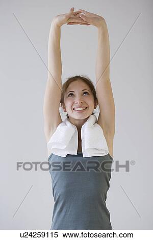 Stock Photography - Woman stretching arms over head. Fotosearch