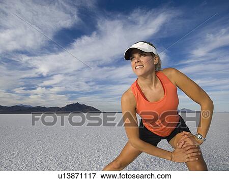 Woman stretching at salt flats, Utah, United States View Large Photo Image Stock Photo - Woman stretching at salt flats, Utah, United States. Fotosearch