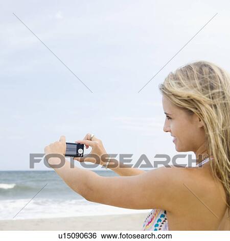 Woman taking photograph of ocean View Large Photo Image Stock Photograph - Woman taking photograph of ocean. Fotosearch