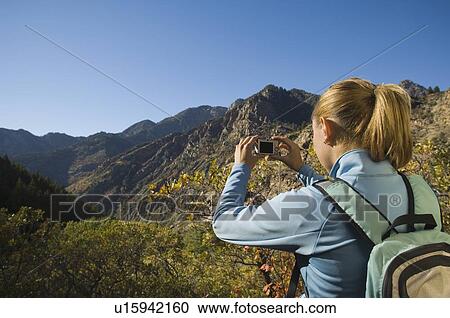 Woman taking photograph of valley, Utah, United States View Large Photo Image Stock Image - Woman taking photograph of valley, Utah, United States. Fotosearch