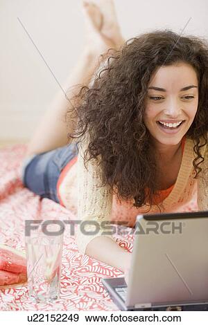 Stock Photo - Woman typing in laptop. Fotosearch
