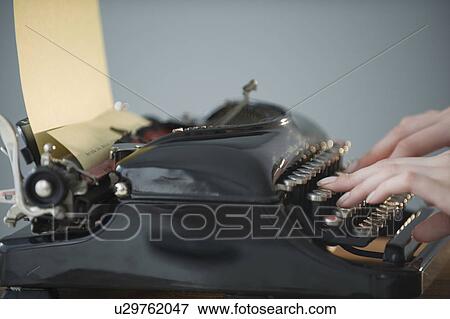 Stock Photo - Woman typing on antique typewriter. Fotosearch