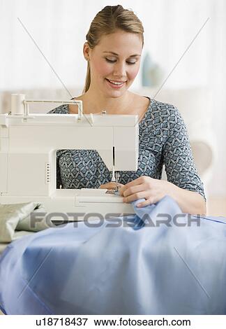 Stock Photo - Woman using sewing machine. Fotosearch