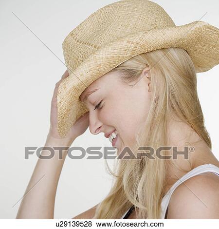 Stock Photo - Woman wearing cowboy hat. Fotosearch