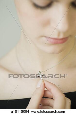 Picture - Woman wearing cross necklace. Fotosearch