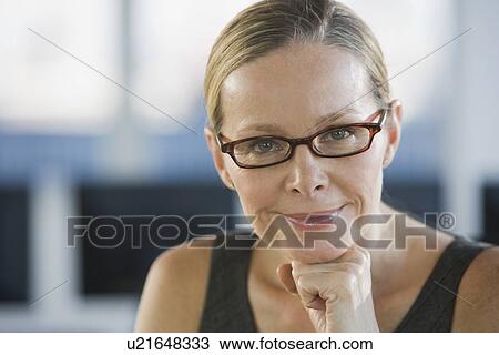 Stock Image - Woman wearing eyeglasses. Fotosearch