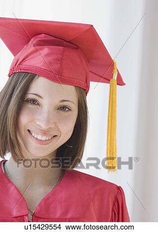 Woman wearing graduation cap and gown View Large Photo Image Picture - Woman wearing graduation cap and gown. Fotosearch