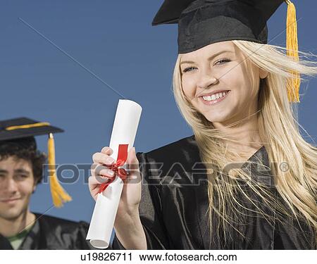 Woman wearing graduation cap and gown with diploma View Large Photo Image Stock Image - Woman wearing graduation cap and gown with diploma. Fotosearch