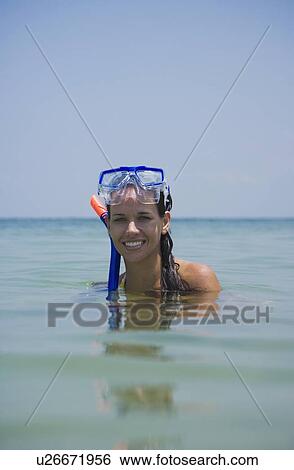 Stock Photograph - Woman wearing snorkeling gear in water, Florida, United States. Fotosearch